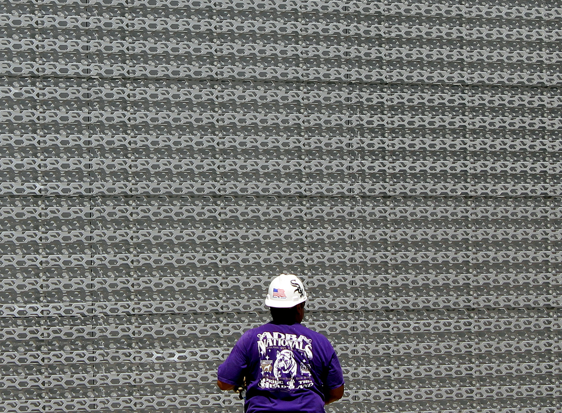 Chain Mail Facade with Purple hard hat. Photograph by Lynn Becker